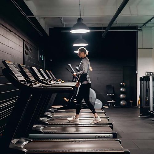 black-gym-with-treadmills-light-ceiling